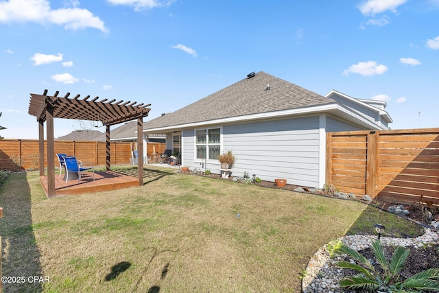 back of house featuring a wooden deck, a fenced backyard, a pergola, a shingled roof, and a lawn