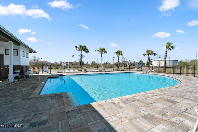 pool featuring a patio and fence