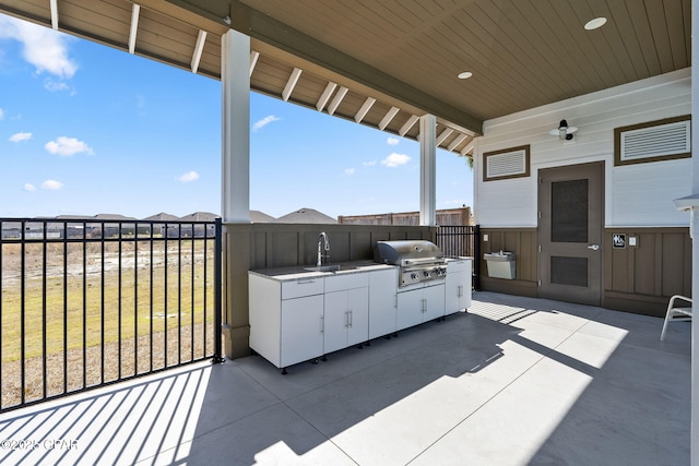 view of patio / terrace featuring a sink, grilling area, and exterior kitchen