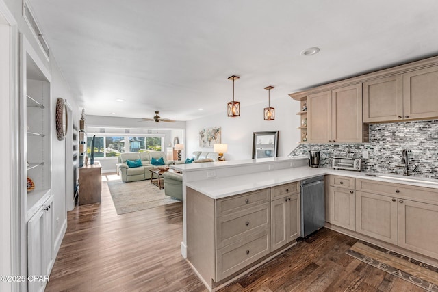 kitchen with a peninsula, open shelves, a sink, dark wood-type flooring, and dishwasher