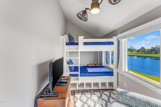 bedroom with vaulted ceiling and wood finished floors