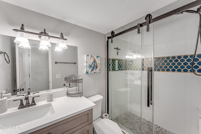 bathroom featuring a stall shower, toilet, and vanity