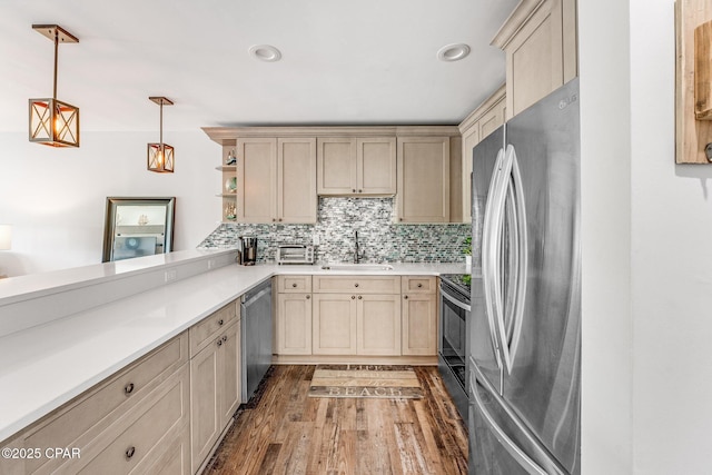 kitchen featuring open shelves, decorative backsplash, appliances with stainless steel finishes, wood finished floors, and a sink