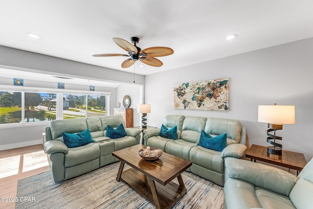 living room with a ceiling fan, recessed lighting, light wood-style floors, and baseboards