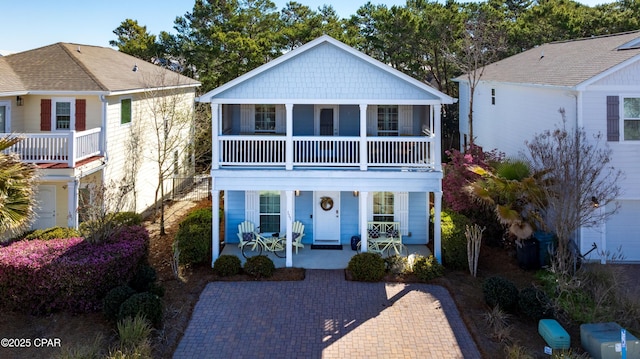 view of front of property featuring a porch and a balcony