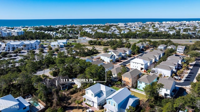 drone / aerial view featuring a residential view and a water view