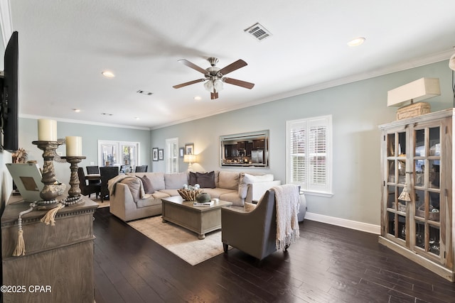 living area with visible vents, ornamental molding, baseboards, and hardwood / wood-style flooring