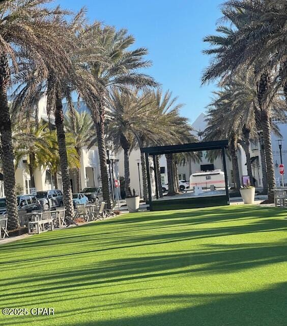 view of property's community with a lawn