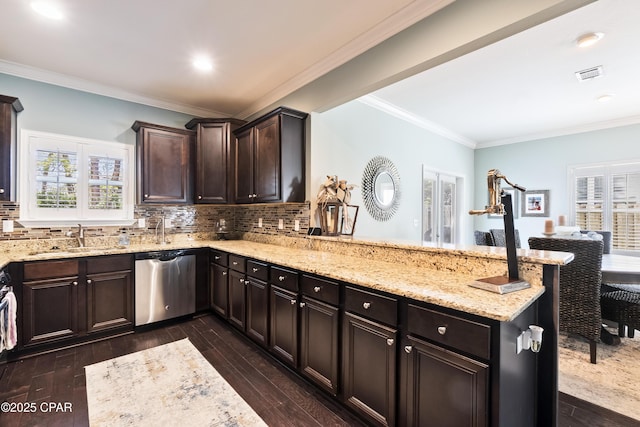 kitchen with stainless steel dishwasher, a peninsula, dark wood-type flooring, and a sink