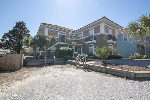 mediterranean / spanish-style home featuring a tile roof