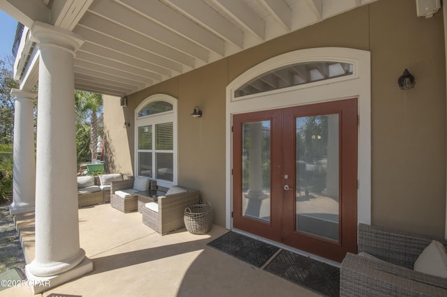 entrance to property with an outdoor hangout area, french doors, and stucco siding