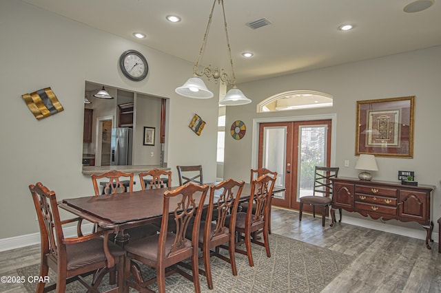 dining area with visible vents, wood finished floors, recessed lighting, french doors, and baseboards