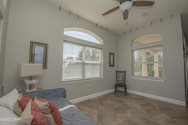 sitting room with plenty of natural light, a ceiling fan, and baseboards