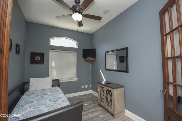 bedroom with wood finished floors and baseboards