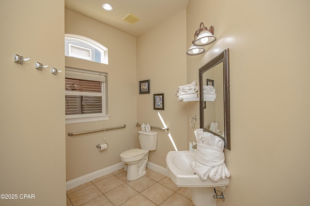 half bath with tile patterned flooring, visible vents, baseboards, toilet, and recessed lighting