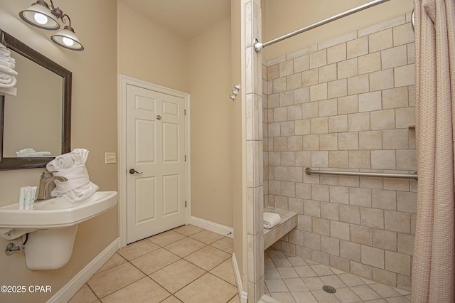 full bathroom with tile patterned floors, baseboards, and a tile shower