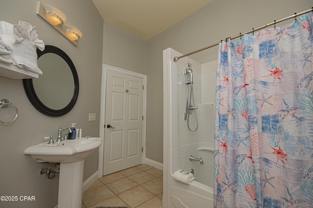 full bathroom with baseboards, shower / bath combo with shower curtain, and tile patterned flooring