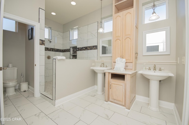 full bathroom with toilet, marble finish floor, recessed lighting, baseboards, and walk in shower