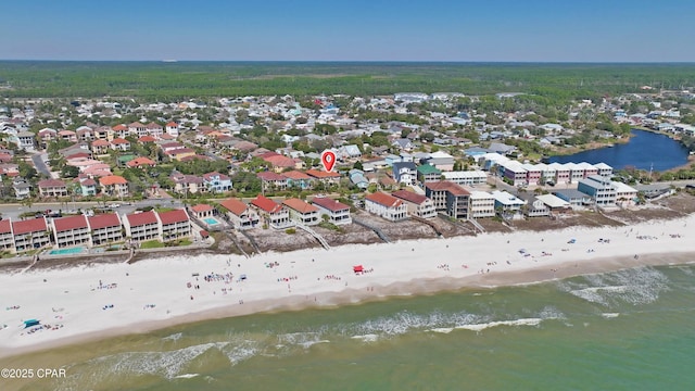 aerial view featuring a view of the beach, a water view, and a residential view