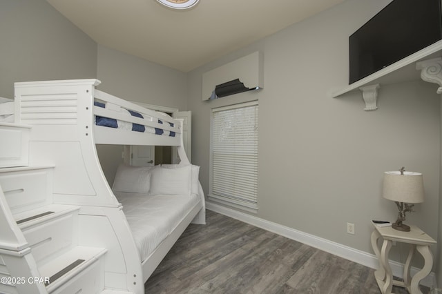 bedroom featuring baseboards and wood finished floors