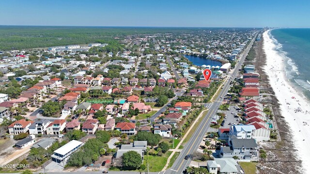 birds eye view of property with a residential view, a water view, and a view of the beach