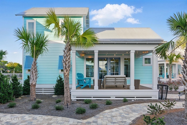 back of property with a porch