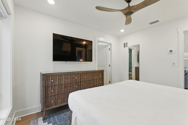 bedroom featuring visible vents, recessed lighting, baseboards, and wood finished floors