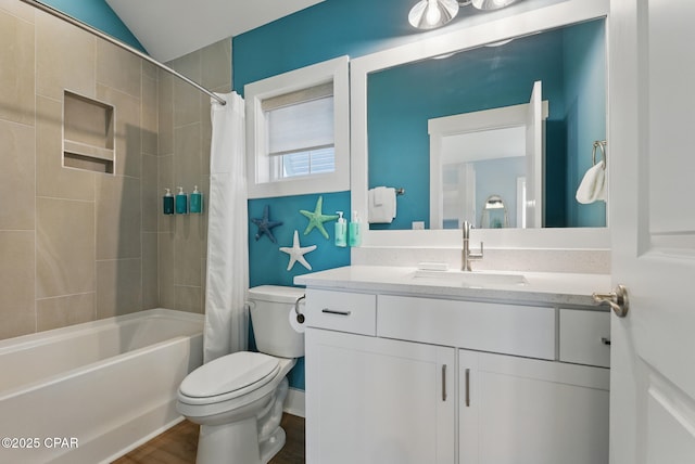 full bathroom featuring toilet, vanity, lofted ceiling, and shower / bath combo