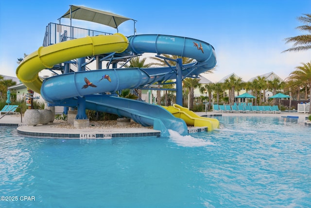 community pool featuring a water slide