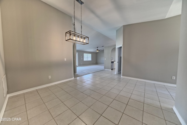 unfurnished dining area with baseboards, light tile patterned flooring, and a ceiling fan