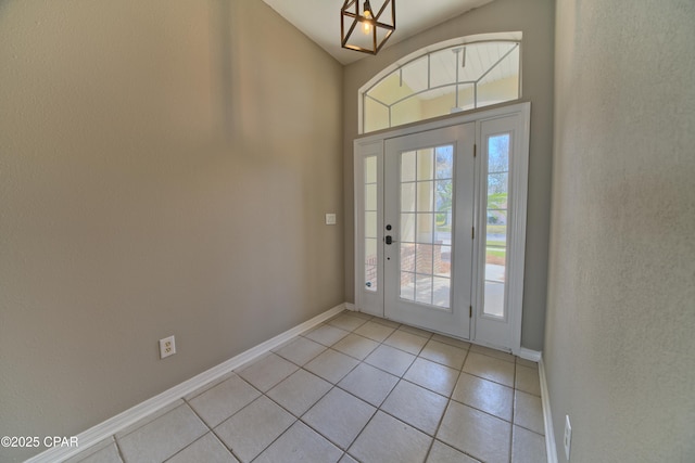 foyer with light tile patterned floors and baseboards