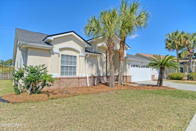 single story home featuring brick siding, a front yard, stucco siding, a garage, and driveway