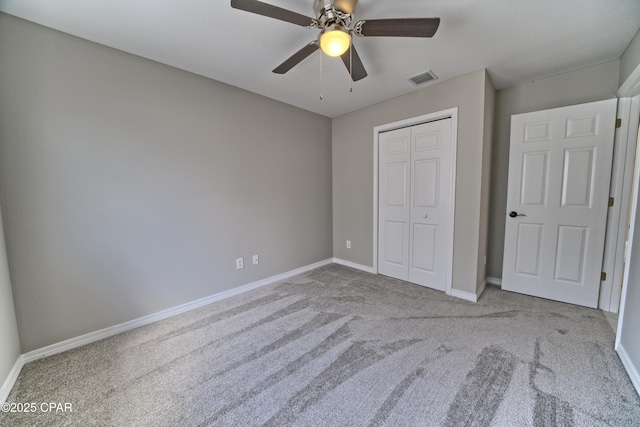 unfurnished bedroom with visible vents, baseboards, carpet flooring, a closet, and a ceiling fan