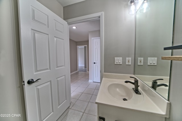 bathroom with tile patterned floors, baseboards, and vanity