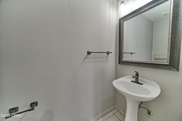 bathroom featuring tile patterned flooring, visible vents, and baseboards