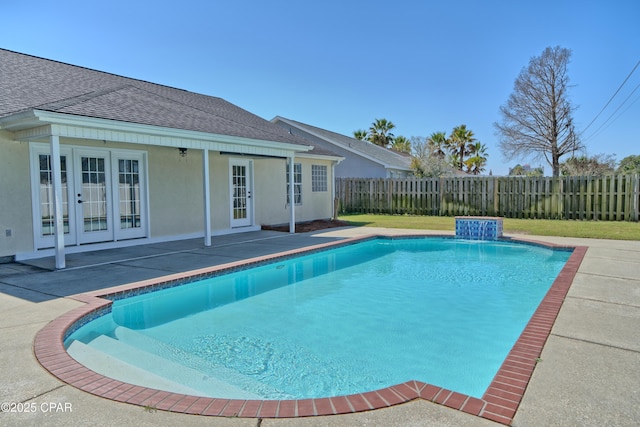 view of swimming pool with a patio area, a fenced in pool, french doors, and a fenced backyard