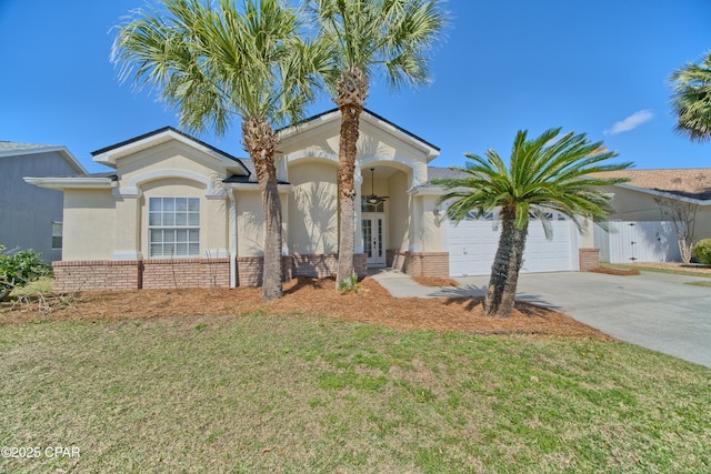 view of front facade with brick siding, stucco siding, french doors, and concrete driveway