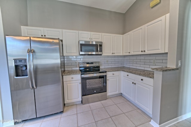 kitchen featuring white cabinets, backsplash, and stainless steel appliances