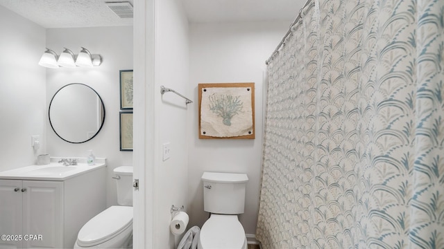 bathroom featuring visible vents, a textured ceiling, toilet, and vanity