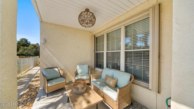 view of patio featuring fence and an outdoor hangout area