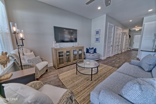 living area with recessed lighting, ceiling fan, baseboards, and wood finished floors