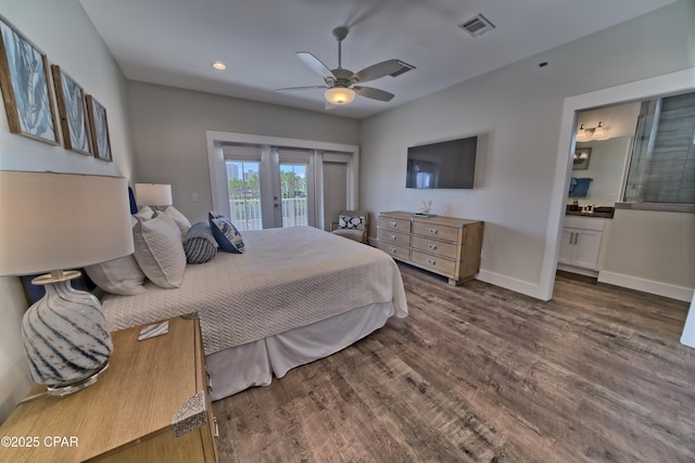 bedroom featuring baseboards, visible vents, access to exterior, dark wood-type flooring, and ensuite bathroom