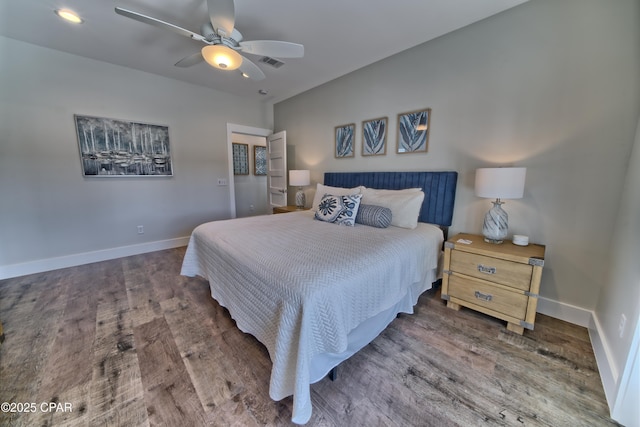 bedroom with wood finished floors, visible vents, and baseboards