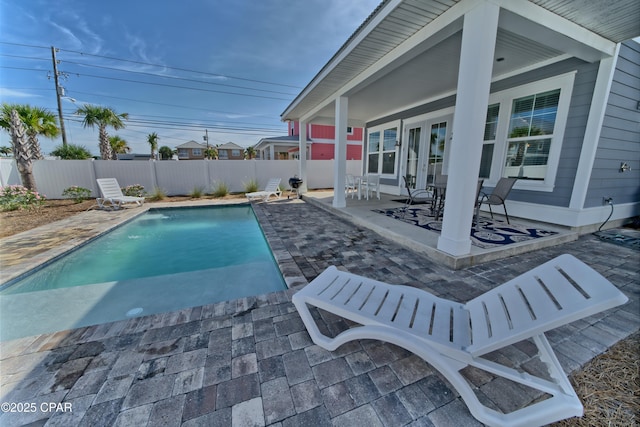 view of swimming pool with a patio area, a fenced in pool, and a fenced backyard