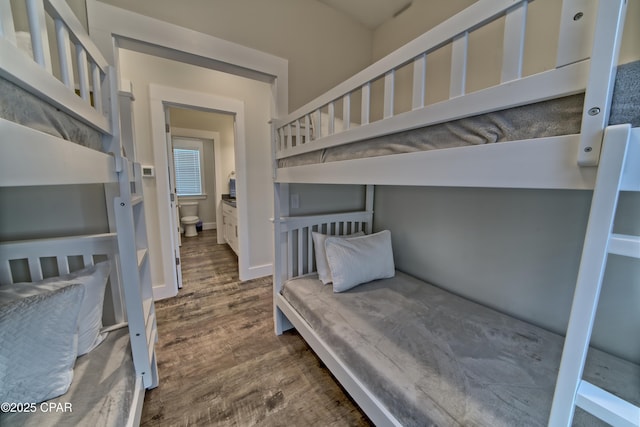 bedroom with baseboards and wood finished floors