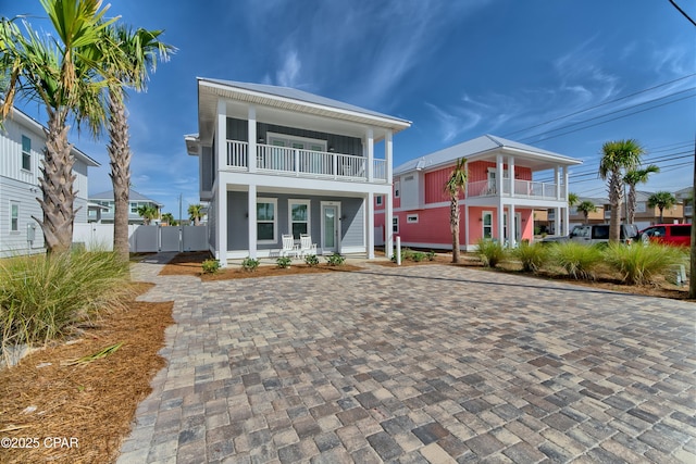 view of front of property featuring a balcony and fence