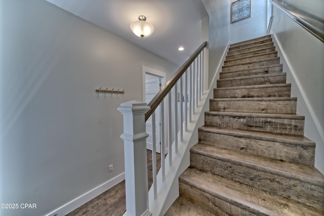 stairs with recessed lighting, wood finished floors, and baseboards