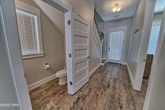 interior space featuring visible vents, toilet, wood finished floors, and baseboards