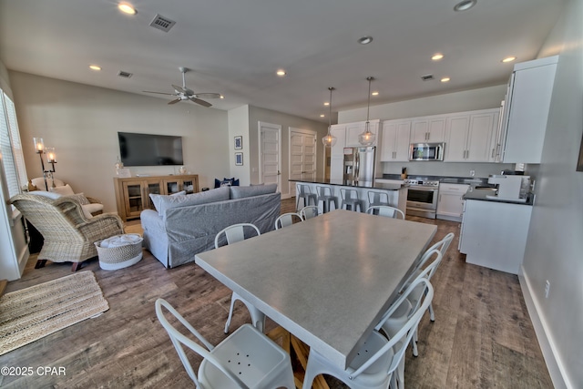 dining room featuring dark wood-style floors, visible vents, recessed lighting, and baseboards