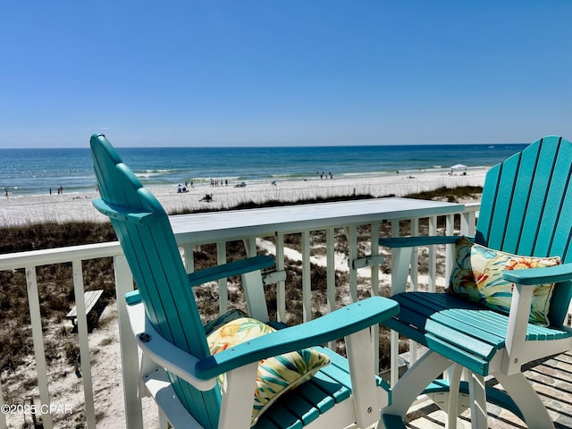 balcony featuring a beach view and a water view